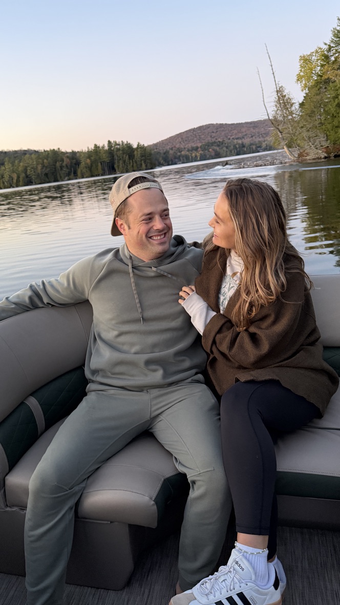 Drew and Katy on a pontoon boat at sunset