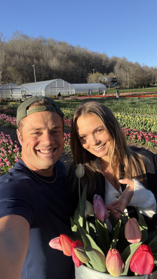 Drew and Katy with a bouquet of tulips at a flower farm