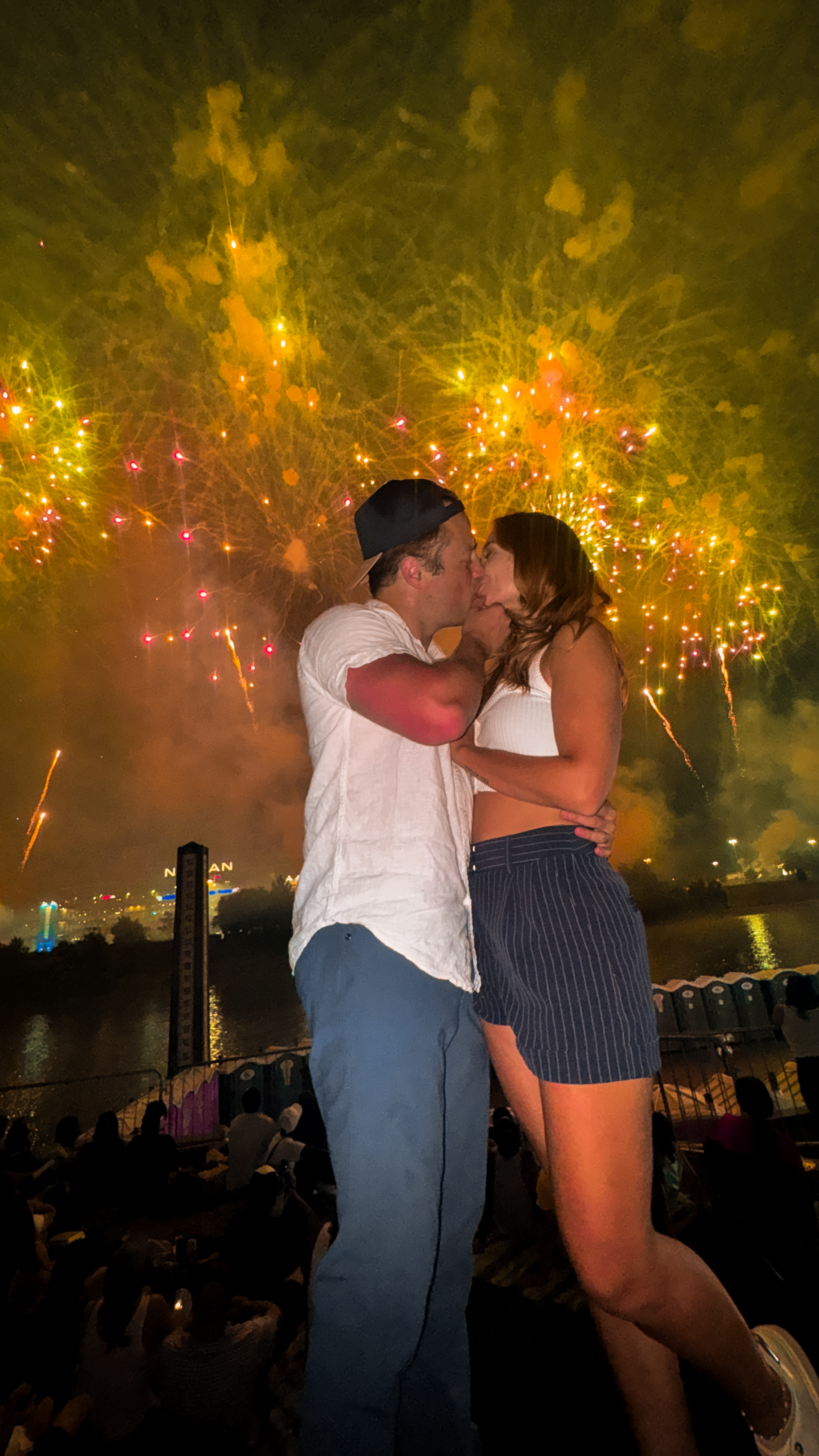 Katy and Drew kissing with fireworks behind them